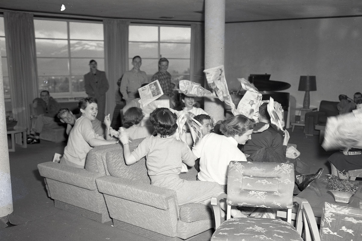 1953: Students Enjoying a Newspaper Fight in Suzanne Homes Residence Hall