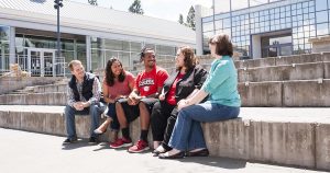 Southern Oregon University Communication Students Sitting in front of the Schneider Museum of Art Enjoying the Sun