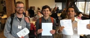 Southern Oregon University 3 Guys Holding Paper