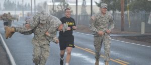 Southern Oregon University Military Science Students Jogging and Carrying Fellow Man