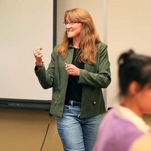 Female Professor Giving Encouraging Message in Classroom