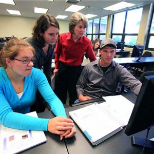 Students and Professor Working on Marketing Computer