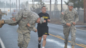 Southern Oregon University Military Science Students Jogging and Carrying Fellow Man