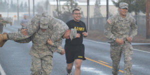 Southern Oregon University Military Science Students Jogging and Carrying Fellow Man on Twitter
