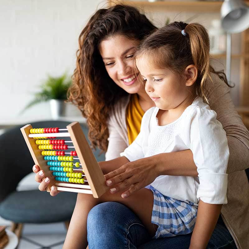 Teaching young student while on teachers lap