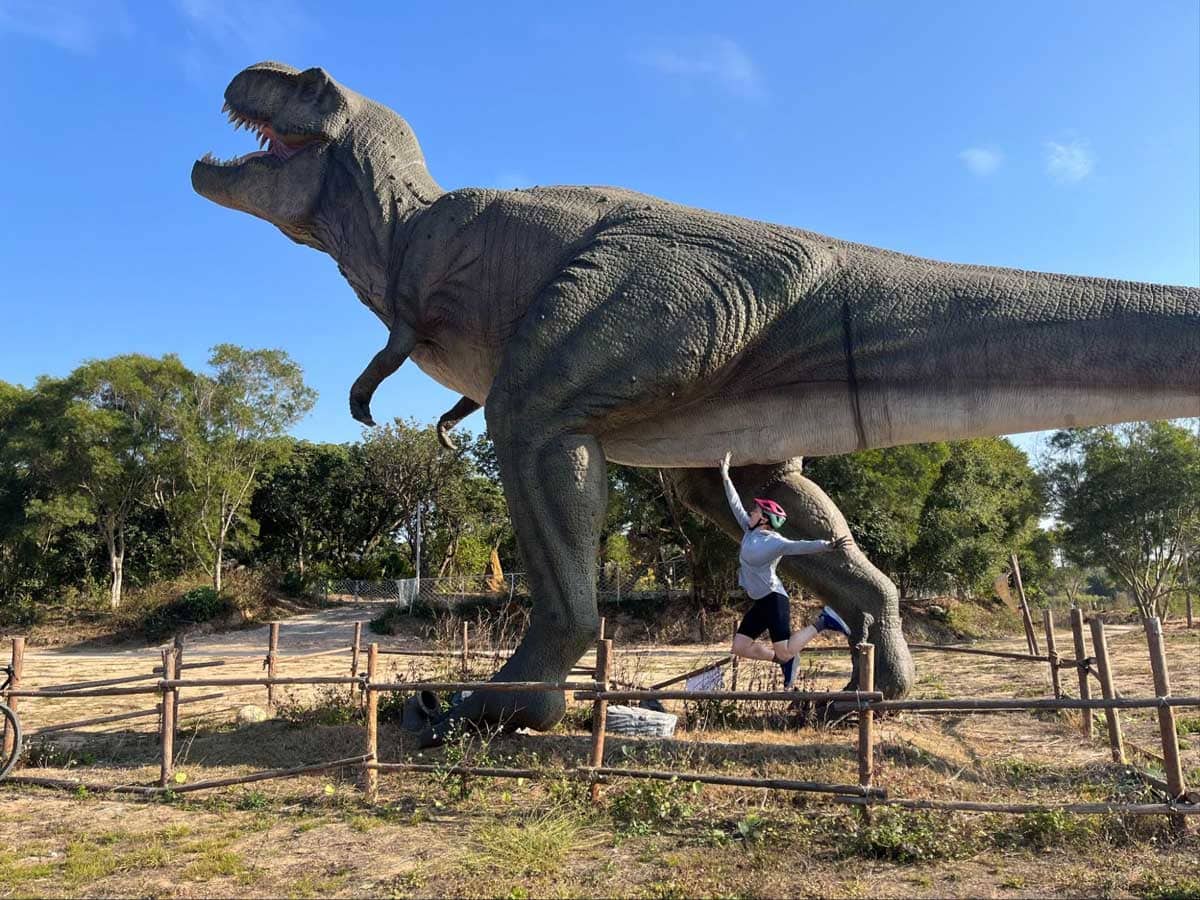 Carly posing next to T-rex in China