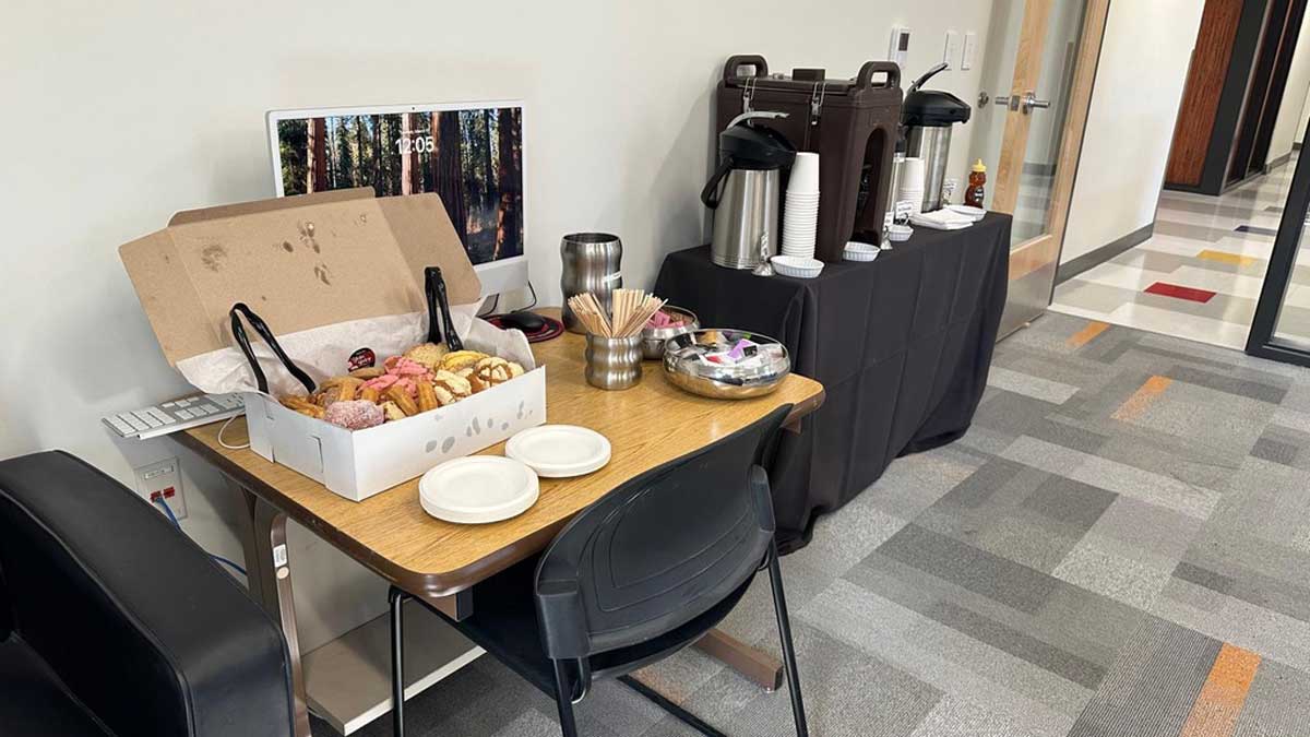 Donut and hot chocolate setup on two tables
