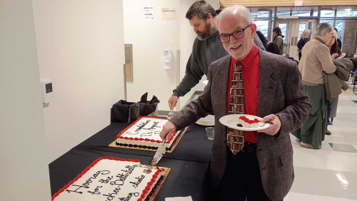 Dr Edwin Battistella getting a slice of cake