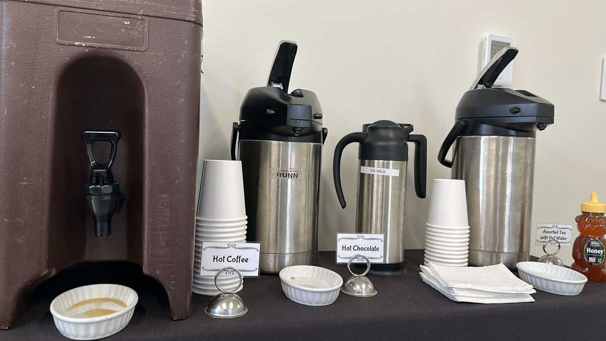 Hot chocolate on table with cups and milk